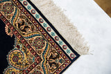 The decorative mixed-weave kilim skirt and ivory fringe on a fine vintage Hereke silk rug.