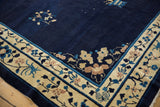 Fluid scrolling floral vine motifs on antique ivory border of Peking carpet.