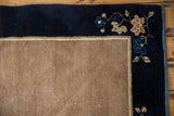 Vintage Peking rug corner: navy blue border, blue and beige blossomed ornamentation, intact selvage.