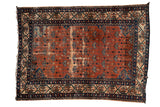 Vintage Malayer rug, burnt orange allover floral field, deep blue borders, noticeable wear.