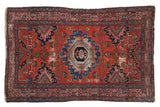 Vintage Malayer rug with brick red field, oversized sapphire blue medallion, and pink geometric patterns.