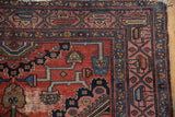Vintage Malayer rug corner with geometric vinery, classic Serbend border, and visible wear.