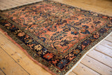 Vintage Lilihan carpet's navy blue border with floral arabesques and fringe detail.