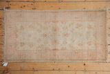 Hand-knotted top right corner of a vintage Dargezine runner with subtle peach and gold floral motifs.
