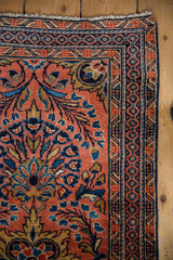 Vintage Dargezine rug corner: dusty brick red, navy floral motifs, blue and gold borders.