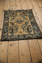 Angled view of a vintage Lilihan rug with textured pile and a small human figure motif.