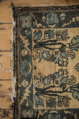 Corner of a distressed Lilihan rug highlighting its worn side and black machine binding.