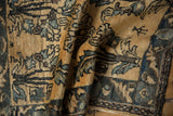 A small human figure motif within the time-softened wool pile of a vintage Lilihan rug.