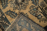 Corner of the vintage Lilihan rug showing its woven foundation and black machine-bound edge.
