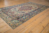 Antique Lavar Kerman rug's sprawling arabesque main border with curvilinear floral details.