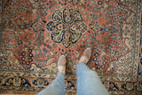 Vintage Arak rug with dusty rose floral blossomed field and navy blue medallion finials.