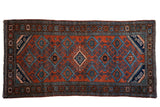 Vintage hand-knotted Mehreban rug, brick red field with geometric blue lattice, floral borders.