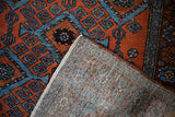 Hand-knotted Persian Mehreban rug detail showing brick red and blue pile and woven foundation.