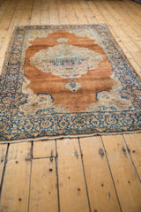 Ornate scalloped medallion, European Rococo influence in time-softened sandalwood and blue.