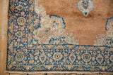 Distressed Kerman rug corner featuring a rich navy border and Rococo-style spandrel.