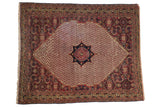 Khorassan rug: navy medallion, ivory boteh field, wine red Herati fish spandrels.