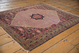Vintage Khorassan rug's navy and red floral medallion and pale field of boteh motifs.