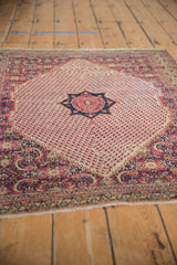 Vintage Persian Khorassan rug corner, classic Herati motif, red boteh field, and even pile wear.