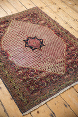 Vintage Khorassan rug corner: ivory fringe, navy selvage, Herati spandrel motif.