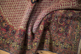 Folded vintage Khorassan rug showing Herati motifs, subtle pile wear, and contrasting lighter foundation.
