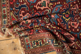 Antique Seichor Kuba rug's geometric border in wine red, indigo, and tattered fringe.
