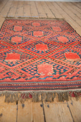 Thick pile of a Beshir rug with madder red gul medallions and blue trellis design.