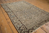 Worn floral vinery pattern on antique ivory Farahan Sarouk rug with charcoal and soft blue border.