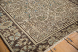 Close-up of antique distressed Farahan Sarouk pile, revealing time-softened floral vinery with muted blue.