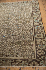 Distressed antique Farahan Sarouk rug: intricate ivory floral vinery and soft blue details.