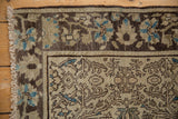 Distressed antique Farahan Sarouk rug corner, with visible even wear on vinery and blue floral motifs.
