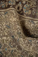 Farahan Sarouk rug with even wear, faint foundation, intricate vinery, and soft blue tones.