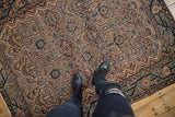 Top-down view of the vintage Malayer rug's detailed floral cartouches and low-pile texture.