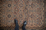 Overhead view of a Malayer rug's intricate field of serrated floral cartouches.