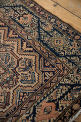 Low pile revealing the intricate texture of a vintage Malayer rug's serrated navy and terracotta patterns.