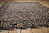 Low angle view across the finely knotted pile of a Persian Malayer rug showing detailed serrated patterns.