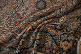 Intricate floral cartouches and serrated vines on the hand-knotted pile of a vintage Malayer rug.