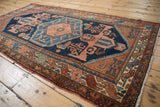 Vintage Mehreban rug with geometric plant motifs, deep blue field, and terra cotta border.