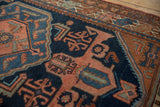 Vintage Mehreban rug detail: terra cotta medallion with germinating plants on deep blue field.