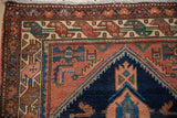 Intricate geometric borders in terra cotta, navy, and oxidized green, from a Vintage Mehreban rug corner.