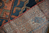Hand-knotted Vintage Mehreban rug's navy, copper, green pile and woven back with side selvage.