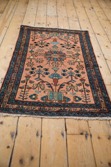 Vintage Lilihan rug corner, dusty rose field, unique blue botanical motifs, navy border.