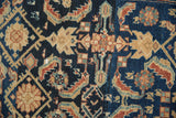 Vintage distressed Lilihan rug's detailed Herati pattern in rich navy and warm beige.