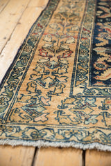 Distressed Lilihan rug, floral border, Herati pattern in navy, sand, terracotta.