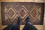 Antique Persian Serab runner featuring a column of three serrated diamond medallions.