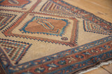 Detail of the intricate checkered pattern and serrated medallion on a camel hair Serab rug.