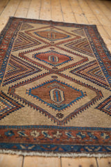Low angle view down the central column of geometric medallions on an antique Camel Hair Serab runner.