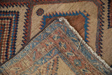 A folded corner reveals the hand-knotted foundation of a collector's antique Serab rug.