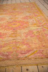 Soft angora wool pile of distressed Oushak rug, with pale raspberry and saffron tones.