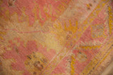 Distressed angora wool pile showing knot heads, with blended raspberry and saffron tones.