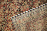 A folded corner compares the distressed Herati pile to the hand-knotted foundation of an antique Senneh.